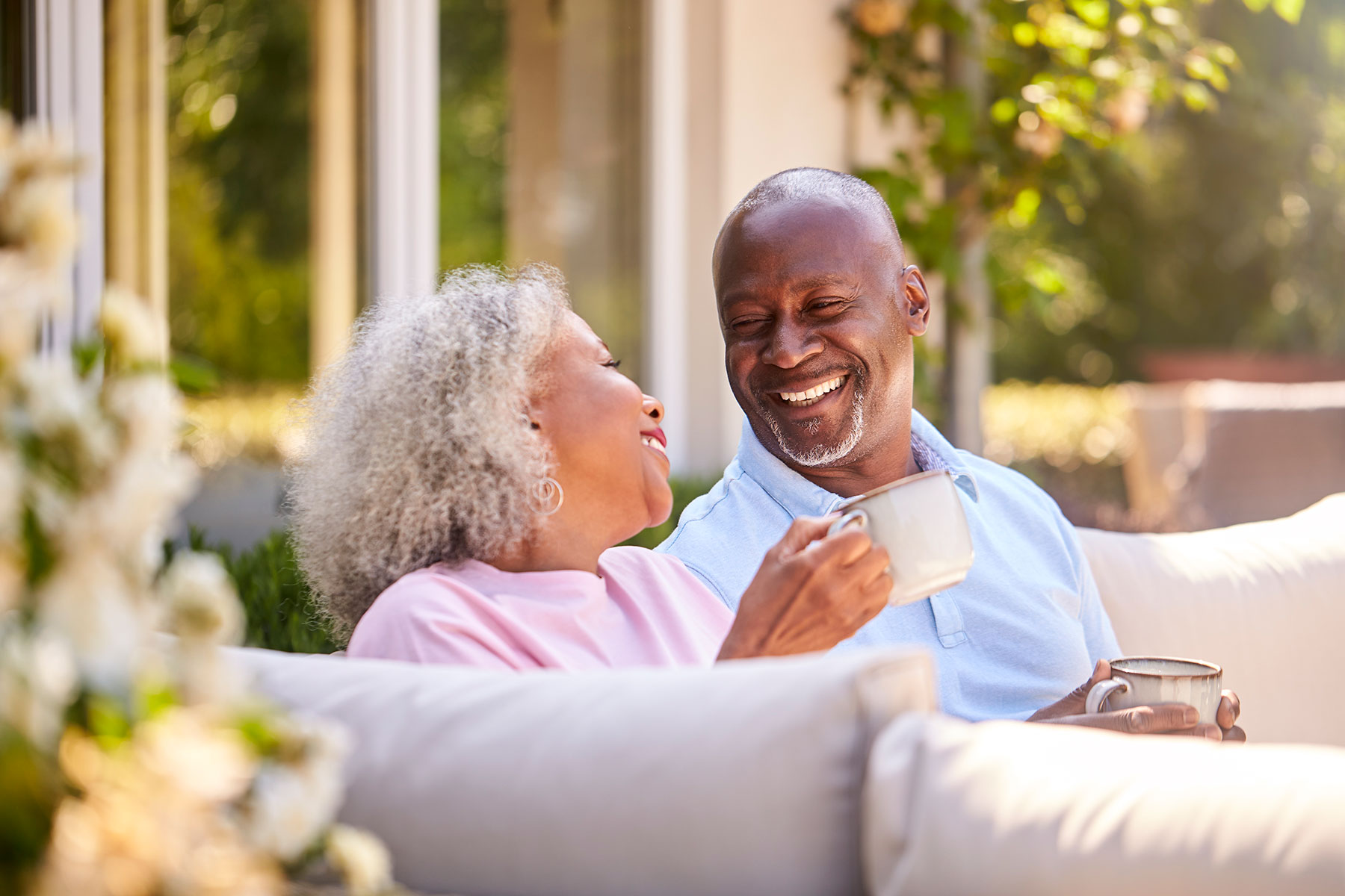 senior African American couple drinking coffee on the couch | Reverse Mortgage Life Expectancy Set-Asides