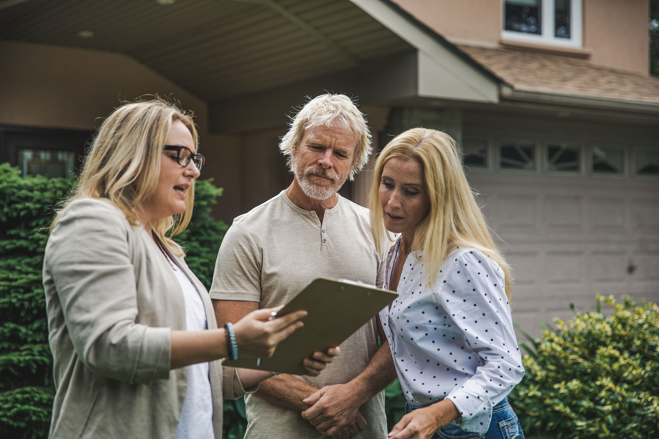 Senior couple reviewing details looking at clipboard