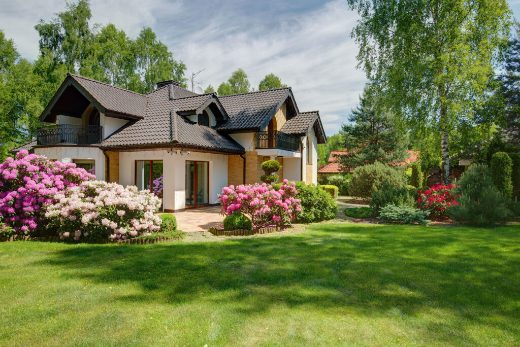 beautiful home with floral bushes