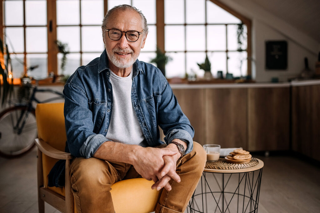 Senior man smiling on stool