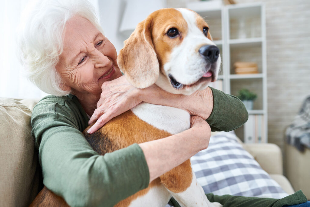 Senior woman hugging dog